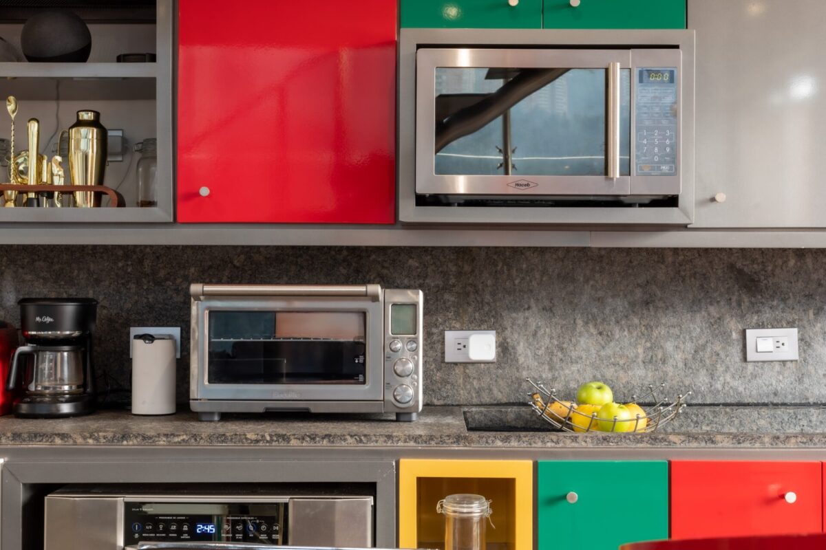 Photo by lissete-laverde-4JhCV1YrG1o-unsplash Silver microwave in a colourful kitchen